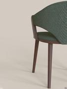 The wooden part of the armrest joins the lower part of the seat, just as the backrest joins at the rear overlapping the structure