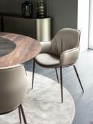 Scarlett dining chair with armrests by Cattelan with upholstered and leather-covered shell and bronze-embossed metal legs