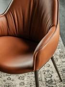 Detail of the armrest that opens outwards from the seat, the profile of which is emphasised by pronounced stitching