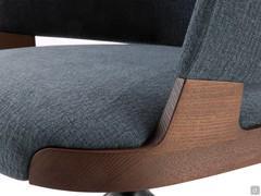 Detail of the grafting of the upholstered parts with the solid ash wood structure, here proposed in the walnut-stained version