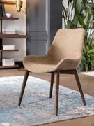 Clara chair upholstered in fabric, with solid ash frame and painted steel spacers. All elements have customisable finishes