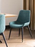 Clara chair with four solid ash legs stained black and steel spacers. Seat and backrest covers include a wide selection of fabrics and velvets