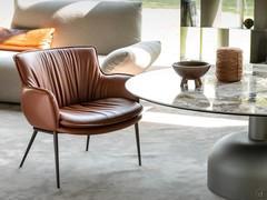 Rhonda chair in the Lounge chair version, with four fixed metal legs. Also available with central swivel base