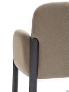 The flat-shaped ash wood legs rise half-way up the backrest, balancing the rounded forms of the armrest and back