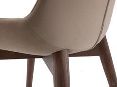 Rear view of the Clara chair, with vertical central seam along the backrest and solid ash frame stained