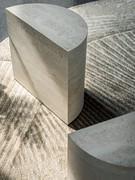 The Domingo coffee table is presented as a single cylindrical block, modelled from keramik stone slabs. A service table, albeit small in size, capable of filling the room with its authoritative form