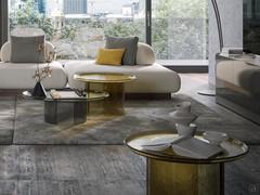 A play of light and transparency defines a composition of three coffee tables designed for a refined living environment