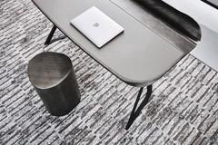Detail of the Cocoon writing desk by Cattelan with ash-coloured leather top and brushed grey lacquered metal shelf groove