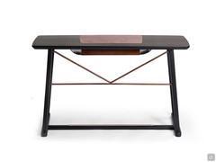 View of the wooden Saul desk from behind, with a painted-metal structure in the Bronze finish matching the footrest and document holder