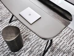 Detail of the Cocoon writing desk by Cattelan with ash-coloured leather top and brushed grey lacquered metal shelf groove