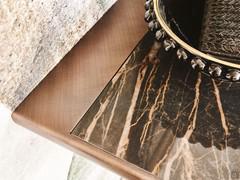 Detail of the Westin console table top in polished Keramik Portoro stone, with brushed bronze metal lacquered frame