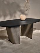 Detail of brushed sheet metal legs with inward fold and bend