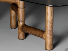 Painted metal inserts contrast gently with the wood of the cylindrical plinth