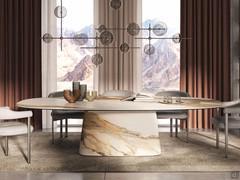 Modern table with central base Napoleon by Cattelan combined with upholstered armchairs Greta. Base and top are in stone Keramik KM18 marble Borghini Calacatta Opaque