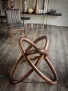 Base with artistic interlaced ring design in Canaletto walnut wood