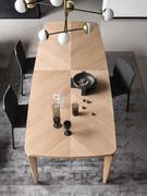 Detail of the wooden top of the Nelia table, with the veneer arranged to form a characteristic cross-grain pattern