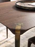 Detail of the perfect joint between the cold-bent steel legs and the solid oak top with shaped edge