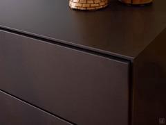 Detail of the 45-degree frame joint: the front of the drawers partially recessed into the thickness of the shell