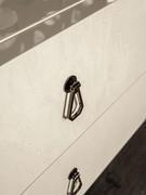 Detail of the metal handle matching the feet