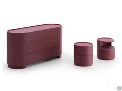Composition 'on white' with the various components of the Chariot group: dresser, 2-drawer bedside table, bedside table with open compartment, all matt burgundy lacquered