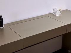 When the dressing table is not in use, the compartment closes to create a single, undivided plane