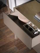 Detail of the dresser's interior finished in matt lacquer to match the structure and drawers. Also visible is the finish of the top in bronzed mirror glass and the characteristic sockets on the top edge inclined at 45°.