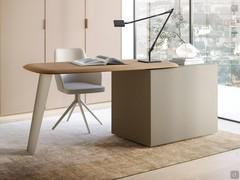 A desk obtained by combining a California desk (in the swivel and shaped version, with a soapboard edge) resting on a back-finished drawer unit