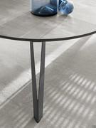 Detail of the painted metal leg profile of the round table with central extensions Space