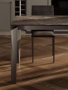 Detail of the leg and undershelf of the extending table Tom, in brushed titanium effect painted metal