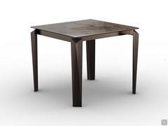 Tom square table in the 90 x 90 fixed version, with glossy Patagonia ceramic glass top and legs in brushed bronze finish