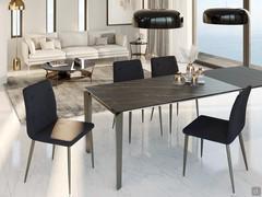 Freddie table in the rectangular extendable version, here proposed with a ceramic noir desir top and anthracite laminate extensions