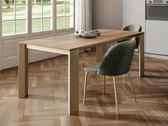 Rog table with champagne varnished metal base, top and extensions in S154 samblé walnut laminated veneer