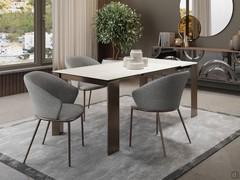 Rog table in glossy onyx amber ceramic glass with extensions in white laminated veneer. Here in size 160 cm with single 45 cm extension leaf