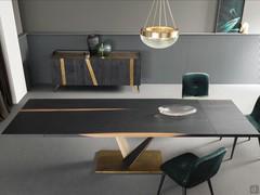 Fortaleza table with a 200 cm top in terracotta oak equipped with an optional extension system. The supports for attaching the extensions, which are contained separately, are 'sunk' directly into the top. Bronze metal base with insert matching the top