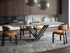 Dionis table in the 250 x 120 cm fixed version, from the base of which grooved legs support the Aubisque stoneware top