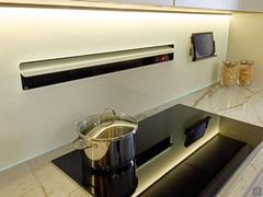 Cooking area of the white and golden kitchen Numa Eleven