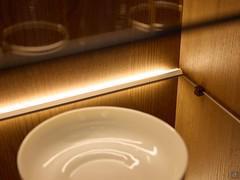 Detail of glass shelves with LED lights at the bottom