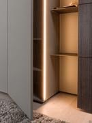 Detail of the protruding door and the built-in LED bar casting indirect light to the open compartment