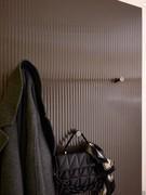 Detail of the coat hooks proposed in bronze painted metal to match the ribbed glass panel