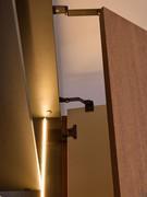 Detail of the special sliding hinges that allow the folding doors to open