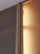 Detail of the closing hinges of the Arctic Wide wardrobe, almost invisible because they are painted to match the frame