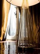 Detail of the lamp base made of ribbed blown glass that creates pleasant plays of light