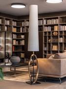 Band floor lamp with metal ring base and large white fabric shade