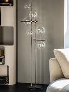 Bloom floor lamp in floor-standing version, elegant and slender, reminiscent of a plant silhouette with stem and foliage 