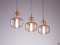 Tetide pendant lamp in linear version with three amber glass shades