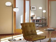 The symmetrical, square shape of the structure contrasts harmoniously with the soft lines of the lampshades