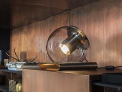 The Globe lamp is characterised by an eye-catching metal base with a curved form which supports the blown glass sphere