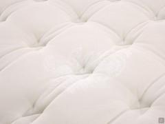 Detail of the cotton fabric upholstery, enriched with a hypoallergenic fibre filling and completed by a precious embroidered quilting with a butterfly design