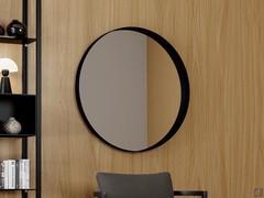 Yukon wall mirror in the 100 cm diameter round version, with a prominent black painted metal frame
