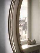 Detail with the mirrored frame reflecting its surroundings